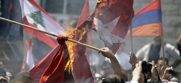 Lebanese Armenians burn the Turkish flag during a protest outside the Turkish embassy in Rabieh, northeast of Beirut, to commemorate the 97th anniversary of the Ottoman Turkish genocide against the Armenian people on April 24, 2012. AFP PHOTO/JOSEPH EID (Photo credit should read JOSEPH EID/AFP/Getty Images)