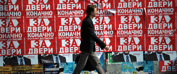 A man walks by an election posters in Belgrade on May 4, 2012. May 6's general elections in Serbia see Boris Tadic's pro-EU camp up against the populists of Tomislav Nikolic against the backdrop of an economic crisis and record unemployment figures. AFP PHOTO / DIMITAR DILKOFF (Photo credit should read DIMITAR DILKOFF/AFP/GettyImages)
