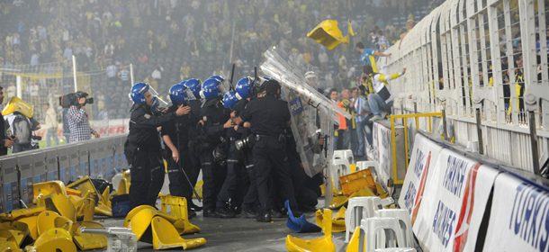 Fenerbahce's fans clash with Turkish riot policemen after the victory of Galatasaray at the end of their Turkish Super League playoff final football match at Sukru Saracoglu Stadium in Istanbul, on May 12, 2012. The game ended with a draw 0-0. AFP PHOTO/BULENT KILIC (Photo credit should read BULENT KILIC/AFP/GettyImages)