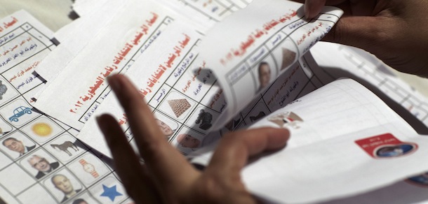 A stack of counted ballets with with Egyptian presidential candidate Abdel-Moneim Abolfotoh checked on the table of a down town polling station and school in Cairo, Egypt, Thursday, May 24, 2012. Nearly a year and a half after the ouster of autocratic leader Hosni Mubarak, millions of Egyptians lined up for hours outside polling stations to freely choose a president for the first time in an election that pits old regime figures promising stability against ascending Islamists seeking to consolidate power. (AP Photo/Fredrik Persson)