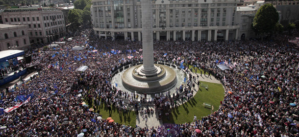 Gergian opposition supporters gather on the square in Tbilisi, the capital of Georgia, Sunday, May 27, 2012, with the column of George the Victorious in the center. Tens of thousands of people have thronged the streets of Georgia's capital to show their opposition to President Mikhail Saakashvili, in the largest anti-government demonstration in three years. The demonstration, which drew at least 40,000 people, was seen as a test of the opposition's public support in Tbilisi ahead of a parliamentary election in October. (AP Photo/George Abdaladze)