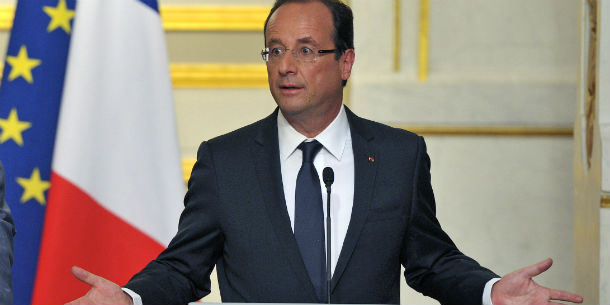 French President Francois Hollande addresses reporters during a joint press conference with Benin and African Union President Thomas Boni Yayi, left, at the Elysee Palace in Paris, Tuesday May 29, 2012. Francois Hollande says Syria's ambassador is being expelled amid continuing violence by Syrian government forces against civilians and opposition members. (AP Photo/Jacques Brinon)