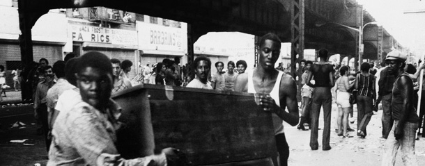 Two men carry a chest down the street in the Bedford-Stuyvesant area of Brooklyn, July 14, 1977, during the power failure that crippled New York. Police reported that looting in some areas of the city continued well into the daylight hours of Thursday. A reported 3,373 persons were arrested for looting and vandalism. (AP Photo)