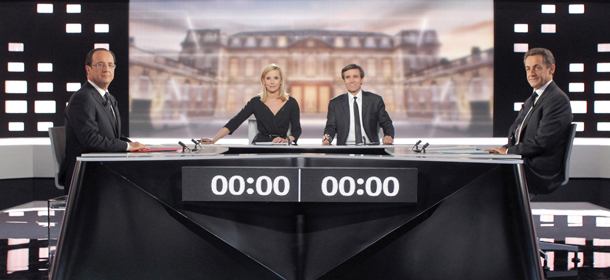 Socialist Party candidate for the presidential election Francois Hollande, left, and current President and conservative candidate for re-election Nicolas Sarkozy , right, pose before a televised debate in Paris, Wednesday, May, 2, 2012. At center are tv hosts Laurence Ferrari, second left, and David Pujadas (AP Photo/Patrick Kovarik, Pool)