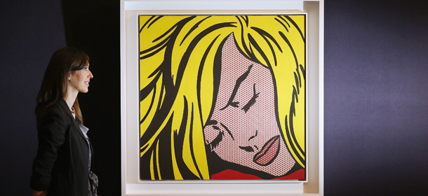 LONDON, ENGLAND - APRIL 12: A woman in Sotheby's auction house views 'Sleeping Girl' by Roy Lichtenstein which is expected to fetch in excess of 25 million GBP on April 12, 2012 in London, England. The painting is to be auctioned alongside 'The Scream' by Edvard Munch which is on public exhibition in London for the first time prior to the 'Impressionist and Modern Art Evening Sale' at Sotheby?s New York on May 2, 2012 where it is expected to fetch in excess of 50 million GBP. (Photo by Oli Scarff/Getty Images)