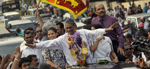 Sri Lanka's former army chief Sarath Fonseka, center, waves to his supporters after being released from jail in Colombo, Sri Lanka, Monday, May 21, 2012. Fonseka's release came after Foreign Minister G.L. Peiris met with U.S. Secretary of State Hillary Rodham Clinton on Friday in Washington, with the protection of human rights highlighted in their meeting. The U.S. has called Fonseka a political prisoner. Fonseka had been credited with leading Sri Lanka's army to victory in the country's long and bloody civil war against ethnic Tamil rebels. But he was jailed after challenging President Mahinda Rajapaksa in 2010 elections. (AP Photo/Eranga Jayawardena)
