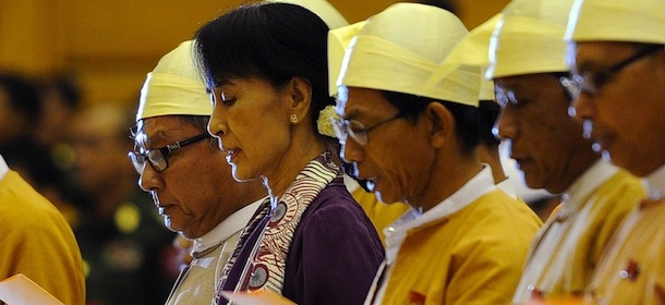 Myanmar opposition leader Aung San Suu Kyi (2nd L) along with other elected members of parliament reads her parliamentary oath at the lower house of parliament during a session in Naypyidaw on May 2, 2012. Myanmar pro-democracy leader Aung San Suu Kyi was sworn in as a member of parliament on May 2, opening a new chapter in the Nobel laureate's near quarter-century struggle against oppression. AFP PHOTO/ Soe Than WIN (Photo credit should read Soe Than WIN/AFP/GettyImages)