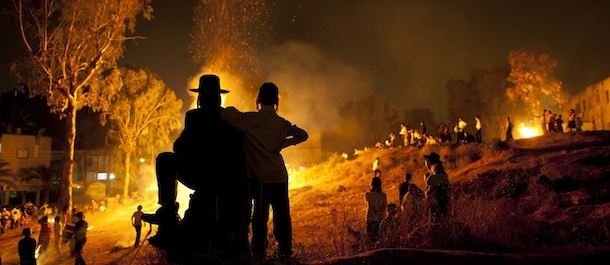 Ultra-Orthodox Jews stand next to bonfires during Lag Ba'Omer celebrations to commemorate the end of a plague said to have decimated Jews in Roman times, in Bnei Brak, Israel, Wednesday, May 9, 2012.(AP Photo/Oded Balilty)