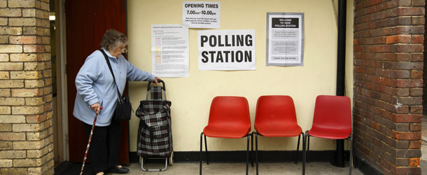 An elderly woman walks out of a polling station for the local elections on a housing estate in northwest London on May 3, 2012. Voters went to the polls in local elections in Britain on May 3, with London mayor Boris Johnson set to stay in office in an Olympic year but the governing coalition expected to take a battering. AFP PHOTO / LEON NEAL (Photo credit should read JUSTIN TALLIS/AFP/GettyImages)