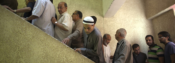 Egyptian men line up to vote at a polling station in Cairo on May 23, 2012, during the country's historic presidential election, the first since a popular uprising toppled Hosni Mubarak. AFP PHOTO/MARCO LONGARI (Photo credit should read MARCO LONGARI/AFP/GettyImages)