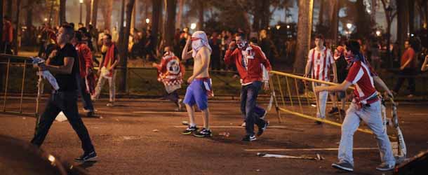 Atletico Madrid supporters clash with police during celebrations in Madrid on May 9, 2012, after the UEFA Europa League final football match between Club Atletico Madrid and Athletic Club Bilbao. A double by Colombian striker Radamel Falcao inspired Atletico Madrid to a 3-0 win over fellow Spaniards Athletic Bilbao and their second Europa League trophy in three seasons. AFP PHOTO / PEDRO ARMESTRE. (Photo credit should read PEDRO ARMESTRE/AFP/GettyImages)