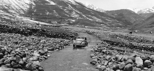 circa 1955: A Volkswagen Beetle fords a stream on the road from Cuzco to Ayacucho. (Photo by Evans/Three Lions/Getty Images)
