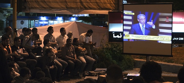 Egyptians watch presidential hopeful candidate moderate Islamist, Abdelmoneim Abul Fotouh (not seen) and former Arab League General Secretary, Amr Mussa speaking during a television live debate at a public screening in Cairo on May 10, 2012. Egypt is set to hold its first ever debate between presidential candidates on Thursday when two frontrunners for this month's election duel it out on television. AFP PHOTO/GIANLUIGI GUERCIA (Photo credit should read GIANLUIGI GUERCIA/AFP/GettyImages)