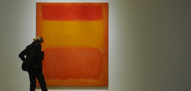 A woman views Mark Rothko's "Orange, Red, Yellow", 1956 on display May 9, 2008 during a preview of the spring sale of Contemporary Art at Sotheby's in New York, to take place May 14-15. The sale price is estimated at USD 35 million. AFP PHOTO/Stan HONDA (Photo credit should read STAN HONDA/AFP/Getty Images)