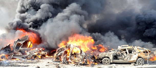 In this photo released by the Syrian official news agency SANA, flames and smoke raise from burning cars after two bombs exploded, at Qazaz neighborhood in Damascus, Syria, on Thursday May 10, 2012. Two large explosions ripped through the Syrian capital Thursday, heavily damaging a military intelligence building and leaving blood and human remains in the streets. (AP Photo/SANA)