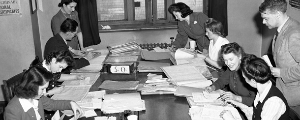 The Pay as you Earn system has deprived Income tax officials in Somerset Hopuse and offices all over Britain of their Easter holiday. Throughout the week-end they have been wrestling with stacks of forms and a special staff of experts has been busy answering enquiries. Income tax officials at work in an office in London, on April 10, 1944. (AP Photo)