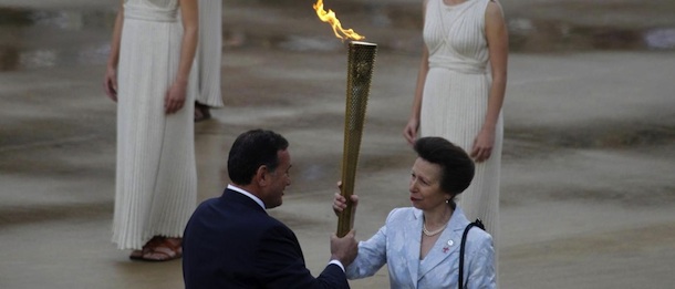 LaPresse17-05-2012SportAtene, la cerimonia di consegna della torcia olimpicaBritain's Princess Anne, right, takes the torch with the Olympic flame from President of the Greek Olympic Committee Spyros Kapralos during a ceremony at Panathinean stadium in Athens, Thursday, May 17, 2012. The torch begins its 70-day journey to arrive at the opening ceremony of the London 2012 Olympics, from the Greek capital, to cover about 8,000-mile (12,875-kilometer) on its progress over many parts of England to start the games.s)