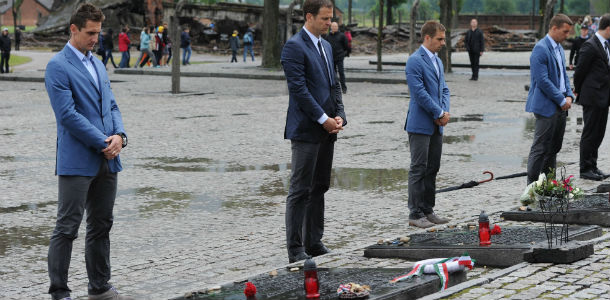 OSWIECIM, POLAND - JUNE 01: Miroslav Klose, Oliver Bierhoff, Philipp Lahm and Lukas Podolsk of Germany place candles as they pay their respects in memory of the victims of the Nazi regime during a visit by a German Football Association (DFB) delegation at the Auschwitz-Birkenau memorial and former concentration camp ahead of Euro 2012 on June 1, 2012 in Oswiecim, Poland. (Photo by Markus Gilliar - Pool/Getty Images)