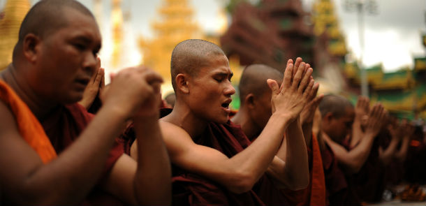 Rakhine Buddhist monks pray as hundreds of demonstrators gather at the Shwedagon pagoda after unrest flared in the western Myanmar state and at least seven people were killed, in Yangon on June 10, 2012. Myanmar on June 10 imposed a curfew in the Rakhine state capital Sittwe, state media reported, amid fears of further unrest following deadly sectarian rioting between Buddhists and Muslims. AFP PHOTO/Soe Than WIN (Photo credit should read Soe Than WIN/AFP/GettyImages)