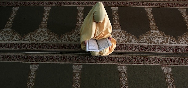 A Palestinian girl reads verses from the Koran during a class on how to read Islam's holy book, at a camp in a local mosque in Gaza City on June 11, 2012. AFP PHOTO/MAHMUD HAMS (Photo credit should read MAHMUD HAMS/AFP/GettyImages)