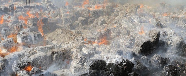 An Indian firefighter (bottom R) attempts to extinguish flames at the Khanna Paper Mill in the outskirts of Amritsar on June 12, 2012. No casualties were reported in the blaze. AFP PHOTO/NARINDER NANU (Photo credit should read NARINDER NANU/AFP/GettyImages)