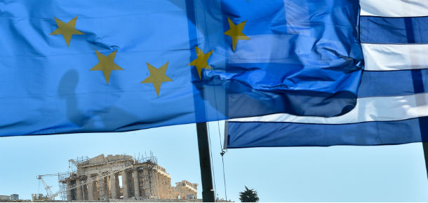 European Union flag and Greek flag wave in front of the Acropolis, in central Athens on June 16, 2012. The radical left's firebrand leader Alexis Tsipras at his final election rally in Athens, accused his main rival, conservative New Democracy leader Antonis Samaras, of defending German Chancellor Angela 'Merkel's Europe of the past.' 'We guarantee the Europe of the future,' he said. AFP PHOTO / ANDREAS SOLARO (Photo credit should read ANDREAS SOLARO/AFP/GettyImages)