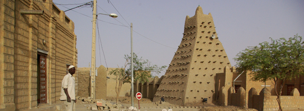 In this Tuesday, May 1, 2012 photo, men work alongside one of Timburktu's historic mud mosques, in Timbuktu, Mali. While government soldiers were fighting each other this week for control of the capital Bamako, in Mali's southwest corner, Islamist fighters were asserting control over the Texas-sized northern half of the country. The Islamists are imposing strict religious law and some of them are foreign jihadists, setting up a possible showdown with Tuareg nationalist rebels, who are secular and who seized northern Mali in March alongside the Islamists. (AP Photo)