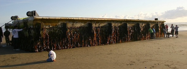 This photo taken Wednesday, June 6, 2012 and supplied by the Oregon Department of Parks and Recreation, shows a large dock that washed ashore early Tuesday on Agate Beach, a mile north of Newport, Ore. The nearly 70-foot-long dock was torn loose from a fishing port in northern Japan by last year's tsunami and drifted across thousands of miles of Pacific Ocean, a Japanese Consulate official said Wednesday.(AP Photo/Oregon Parks and Recreation)