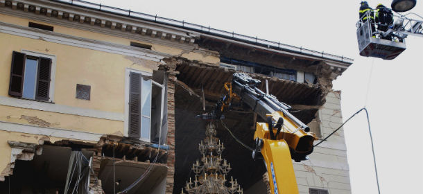 RETRANSMISSION FOR ALTERNATIVE CROP In this photo taken Monday, June 4, 2012 and released by the Consorzio Promovetro Murano Friday, June 8, 2012, a four century-old crystal chandelier is being removed from the Sant'Agostino town hall, which was damaged in a quake last month. Four crystal amber and gold chandeliers were gingerly removed from the city hall and moved to the Palazzo Ducale in nearlby Sassuolo, where they will be restored. A fifth chandelier was lost under the rubble of the May 20 quake. It is not known if the remaining chandeliers will return to their original location, as the town hall is expected to be demolished. The largest chandelier, weighing 300 kilograms (more than 660 pounds), is worth €200,000 ($250,000). (AP Photo/Consorzio Promovetro Murano)