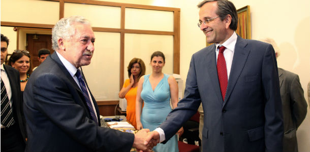 Leader of the New Democracy conservative party Antonis Samaras, right, welcomes Democratic Left party leader Fotis Kouvelis prior their meeting at the Greek parliament, in Athens, on Monday, June 18, 2012. Samaras, who came first in Sunday's national election, said he will meet with leaders of all parties "that believe in Greece's European orientation and the euro" this afternoon in order to form a new coalition government. (AP Photo/Petros Giannakouris)
