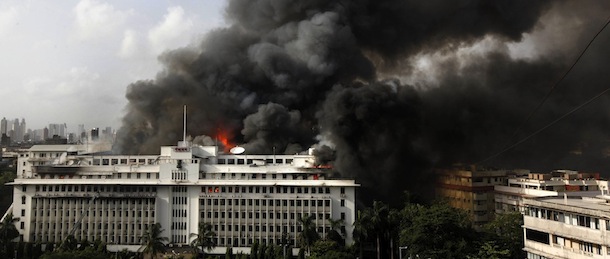 Indian firefighters work to extinguish a fire as smoke billows from the headquarters of the Maharashtra state government in Mumbai, India, Thursday, June 21, 2012. Hundreds of employees were evacuated Thursday from the seven-story government building as more than two dozen fire engines battled the major fire that raged for more than three hours in India's financial and entertainment capital. (AP Photo/Rafiq Maqbool)