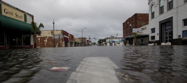 Water laps up against sand bagged businesses in downtown Live Oak Fla., Tuesday, June 26, 2012. The water was still rising Tuesday evening after Tropical Storm Debby dumped torrential rains on the area. (AP Photo/Dave Martin)