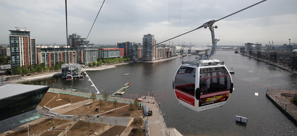 LONDON, ENGLAND - JUNE 28: A cable car leaves the Emirates Royal Docks station during the launch of the newly opened Emirates Air Line cable car which operates between the O2 Arena in Greenwich and the ExCeL exhibition centre at the Royal Docks on June 28, 2012 in London, England. The service crosses the Thames at a speed of 8.9 miles per hour and at a height of almost 300ft; is capable if carrying up to 2,500 people per hour. (Photo by Oli Scarff/Getty Images)