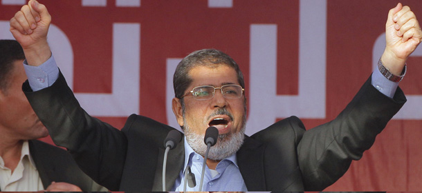 Egypt's President-elect Mohammed Morsi talks to his supporters at Tahrir Square, the focal point of Egyptian uprising, during his speech in Cairo, Egypt, Friday, June 29, 2012. Egypt's newly elected president has read that oath of office in Tahrir Square packed with tens of thousands of Islamists chanting against the ruling military council. In a strong-worded speech that meant to assuage popular anger at the military generals, Morsi showed defiance attempts to chip away from his own presidential powers. (AP Photo/Amr Nabil)