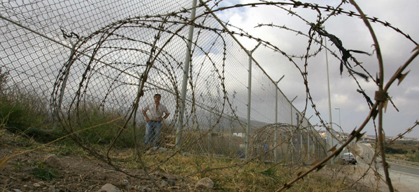 MELILLA, Spain: A man looks at the perimeter fence marking the border between the Spanish enclave of Melilla and Morocco in Melilla, 26 September 2005. Spain has decided to double the height of the chain-link fence which marks the border around the Spanish enclave of Melilla in northern Morocco to discourage illegal immigrants from attempting to enter. Since the beginning of this year there have been nearly 12,000 attempts to cross the border between Morocco and Melilla, which as Spanish territory is a gateway to Europe's Schengen open-borders region. AFP PHOTO/ Pierre-Philippe MARCOU (Photo credit should read PIERRE-PHILIPPE MARCOU/AFP/Getty Images)