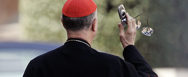 Italian Cardinal Tarcisio Bertone uses his mobile phone as he leaves the Paul VI hall at the end of the General Congregation assembly of the Cardinals at the Vatican, 15 April 2005. Cardinals start their conclave in the frescoed Sistine Chapel on April 18 and will vote twice a day thereafter until one candidate has reached a majority of two thirds plus one. (Photo credit should read MARCO LONGARI/AFP/GettyImages)