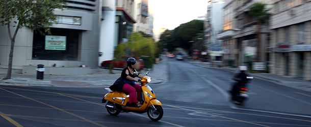 A woman rides her scooter in the empty city center of Nicosia on June 5, 2012. Eurozone member Cyprus conceded that there is a serious possibility it may need an EU bailout to save its banking system, which is heavily exposed to Greek debt. AFP PHOTO / PATRICK BAZ (Photo credit should read PATRICK BAZ/AFP/GettyImages)
