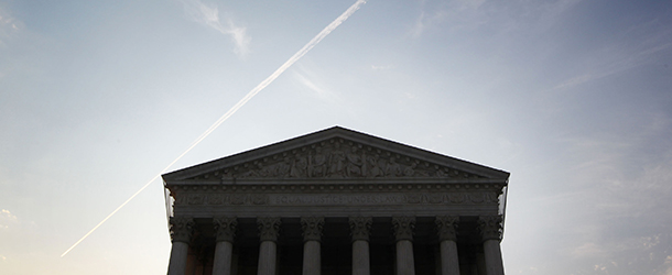 WASHINGTON, DC - JUNE 25: A plane flies over the U.S. Supreme Court on June 25, 2012 in Washington, DC. The Supreme Court is expected to hand down its ruling on the Healthcare Reform Law soon. (Photo by Alex Wong/Getty Images)