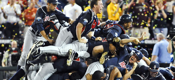 Arizona players pile up following their 4-1 victory over South Carolina in Game 2 to win the NCAA College World Series baseball finals in Omaha, Neb., Monday, June 25, 2012. (AP Photo/Dave Weaver)