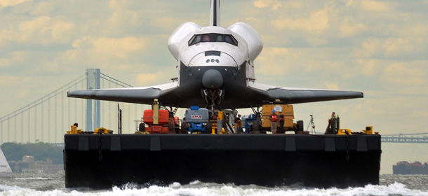 The space shuttle Enterprise is towed by barge through the harbor in New York June 6, 2012 to the Intrepid Sea, Air and Space Museum where it will be permanently displayed. AFP PHOTO/Stan HONDA (Photo credit should read STAN HONDA/AFP/GettyImages)