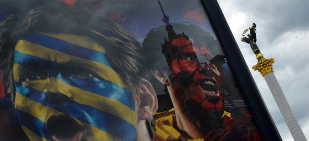 A monument is seen at football themes placard set in a fanzone on Independence Square in Kiev on May 31, 2012. AFP PHOTO/ SERGEI SUPINSKY (Photo credit should read SERGEI SUPINSKY/AFP/GettyImages)