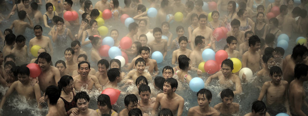 In this Sunday, Oct. 30, 2011 photo, tourists crowd a hot spring pool in southwestern China's Chongqing city. Countries around the world marked the world's population reaching 7 billion Monday, Oct. 31 with lavish ceremonies for newborn infants symbolizing the milestone and warnings that there may be too many humans for the planet's resources. While demographers are unsure exactly when the world's population will reach the 7 billion mark, the U.N. is using Monday to symbolically mark the day.(AP Photo) CHINA OUT
