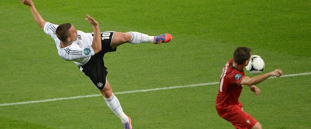 German forward Lukas Podolski (L) kicks the ball in front of Portuguese defender Joao Pereira during the Euro 2012 championships football match Germany vs Portugal on June 9, 2012 at the Arena Lviv. AFP PHOTO / ANNE-CHRISTINE POUJOULAT (Photo credit should read ANNE-CHRISTINE POUJOULAT/AFP/GettyImages)