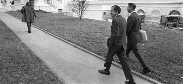 FILE - In this Dec. 19, 1969, file photo President Nixon walks with his assistant H.R. Haldeman from the Executive Office Building to the White House for a Cabinet meeting. Two pages of notes written by Haldeman from a June 20, 1972, meeting with Nixon will undergo forensic analysis at the National Archives to see if they hold clues to one of the Watergate scandal's enduring mysteries. Researchers hope to learn what Nixon said during the infamous 18 1/2-minute gap in a tape recording of his meeting with Haldeman that day. (AP Photo/File)