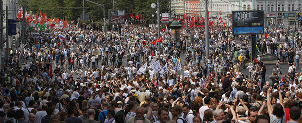 Opposition members march in central Moscow on Tuesday, June 12, 2012. Tens of thousands of Russians flooded Moscow's tree-lined boulevards Tuesday in the first massive protest against President Vladimir Putin's rule since his inauguration, as investigators sought to raise the heat on the opposition by summoning some of its leaders for questioning just an hour before the march. (AP Photo/Alexander Zemlianichenko)