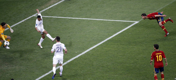 Spain's Xabi Alonso, right, scores the opening goal past France goalkeeper Hugo Lloris during the Euro 2012 soccer championship quarterfinal match between Spain and France in Donetsk, Ukraine, Saturday, June 23, 2012. (AP Photo/Vadim Ghirda)