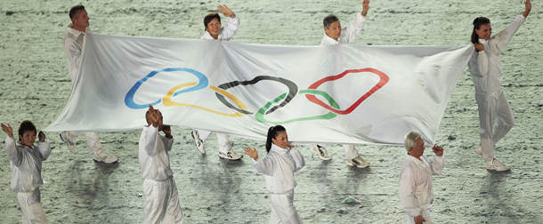 SINGAPORE - AUGUST 14: The 8 Olympians carry the Olympic Flag to the Opening Ceremony of the 2010 Youth Olympics at The Float@Marina Bay on August 14, 2010 in Singapore. (Photo by Adam Pretty/Getty Images)
