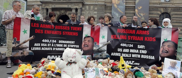 Opponents to Syrian President hold a banner which denounced the killing of Syrian children by Russian arms, in front of Le Louvre museum on June 12, 2012 in Paris. The event takes place as the Eurosatory 2012 defence and security exhibition runs in Villepinte near Paris until June 15. UN peacekeeping chief Herve Ladsous said on June 12 that Syria is now in a full-scale civil war as President Bashar al-Assad's military battles opposition forces around the country. AFP PHOTO / PIERRE VERDY (Photo credit should read PIERRE VERDY/AFP/GettyImages)