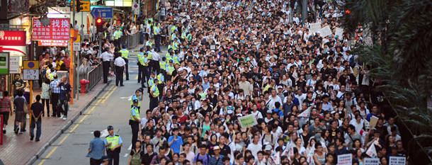 Thousands of protesters take to the streets calling for universal suffrage and chanting slogans against new Hong Kong Chief Executive Leung Chun-ying in Hong Kong on July 1, 2012 only hours after Chinese President Hu Jintao completed his three-day visit to the southern Chinese territory. Hong Kong's new leader Leung Chun-ying, who earlier in the day was sworn in at an inauguration ceremony, took over the city of seven million people amid falling popularity ratings, a series of setbacks and protests over his leadership before he even started his term. AFP PHOTO / RICHARD A. BROOKS (Photo credit should read RICHARD A. BROOKS/AFP/GettyImages)