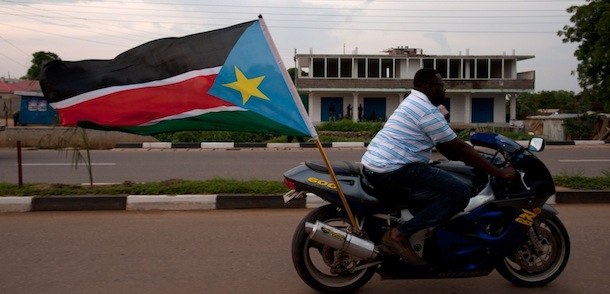 A man rides a motorbike with a South Sudanese flag during celebrations in the streets of Juba ahead of South Sudan's independence first anniversary, on July 8, 2012. AFP PHOTO / Giulio Petrocco (Photo credit should read Giulio Petrocco/AFP/GettyImages)